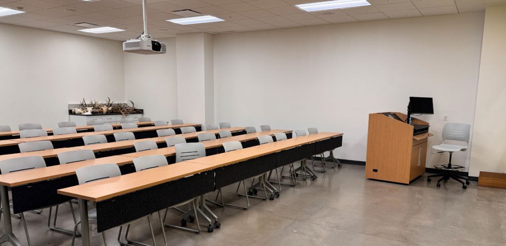 ANR G006 with rows of tables and chairs facing the front of the classroom