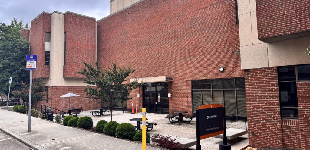brick building with sign saying Blount Hall steps lead down to entrance, ramp nearby