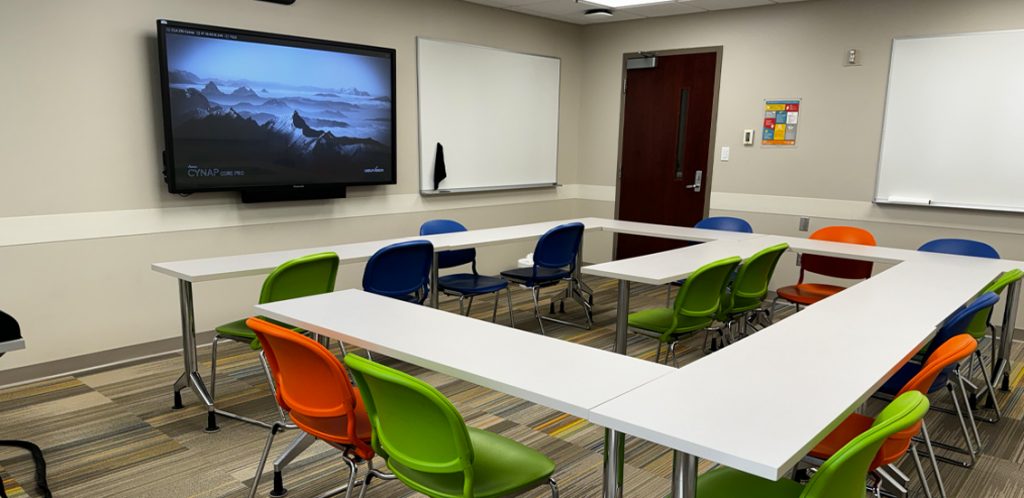 Claxton Education Building Room 210 with tables in square with chairs in square around tables