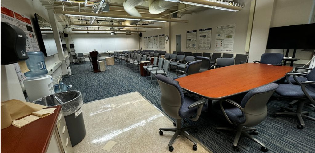 Claxton Room 233 tables chairs lined up against the wall with conference table to the side