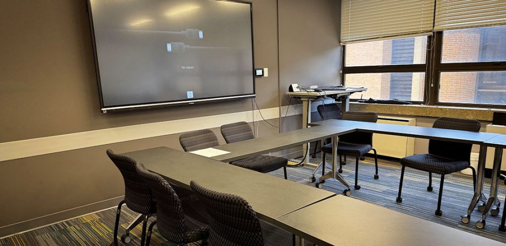 McClung Tower room 201, tables and chairs formatted in a square