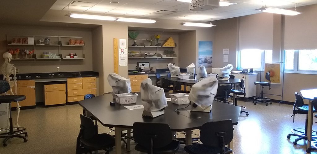 Strong 211. Room includes lab tables and chairs.