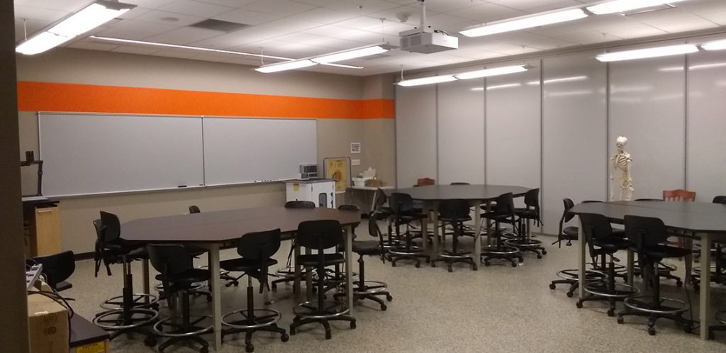 Strong 222. Room includes lab tables and chairs.